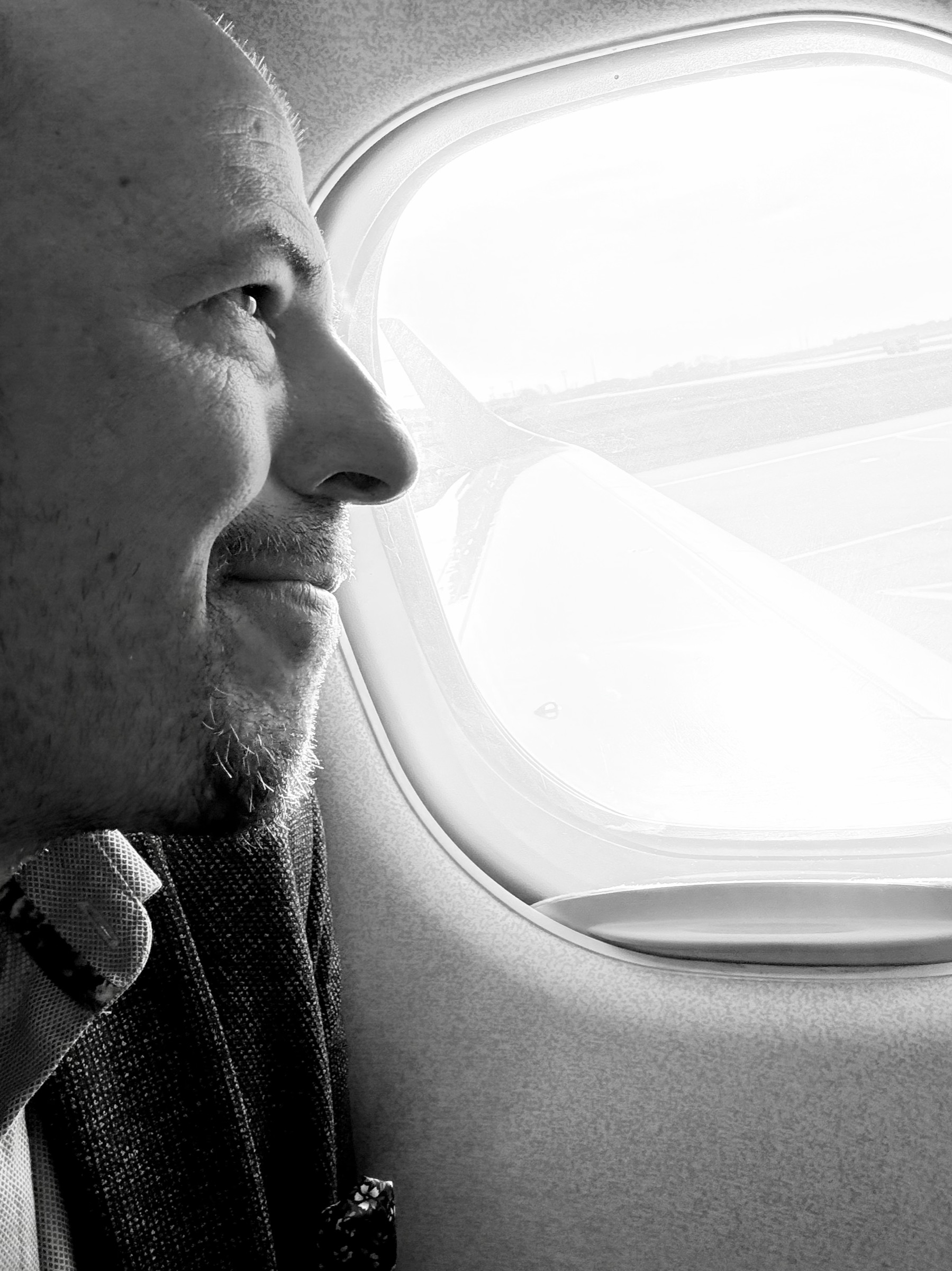 Philipp von Bentivegni in profile, looking out of an airplane window